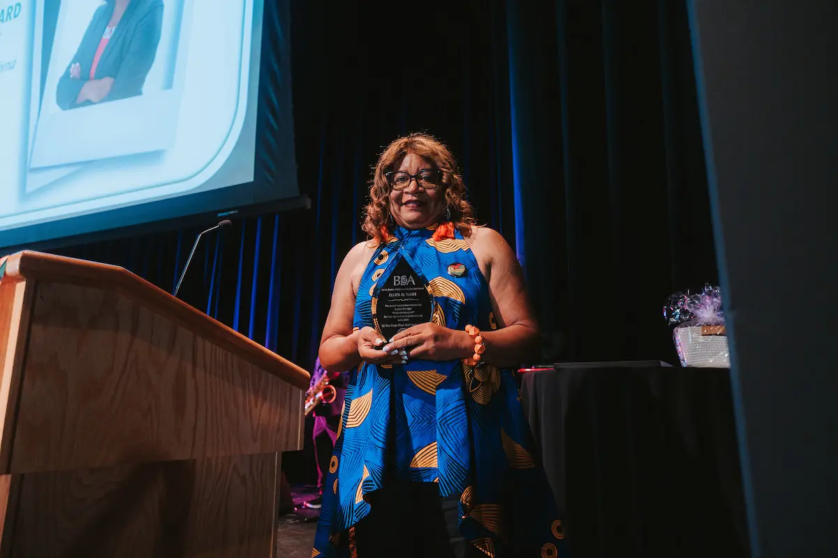 Ellen D. Nash, standing at a podium